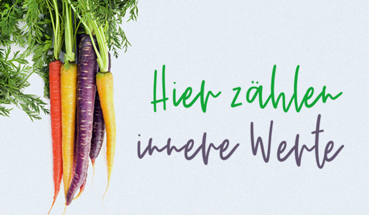 Bunte Möhren mit der Schrift "Hier zählen die inneren Werte"